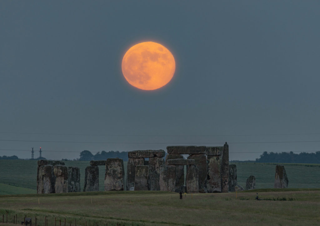 The Strawberry Moon rising over Stonehenge in Wiltshire