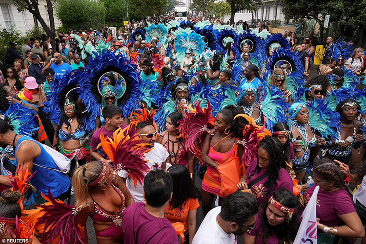 Carnivalgoers put on a colourful display as the carnival weaved its wave through the streets of Notting Hill this afternoon
