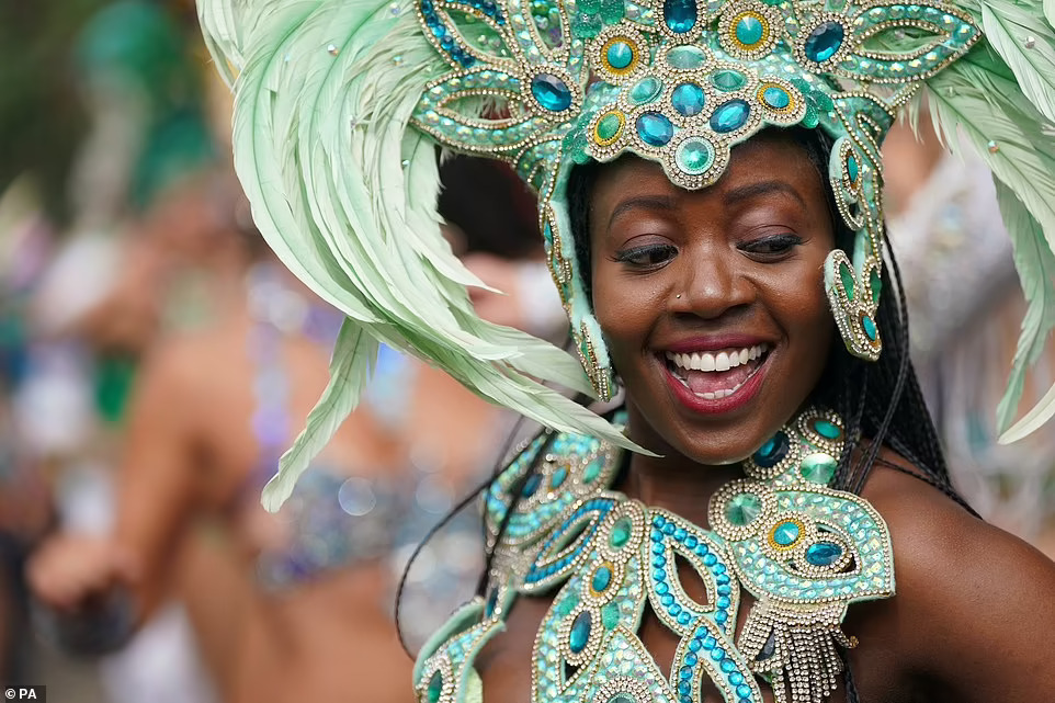 Samba dancers performers take part in the Notting Hill Carnival in West London August 2022