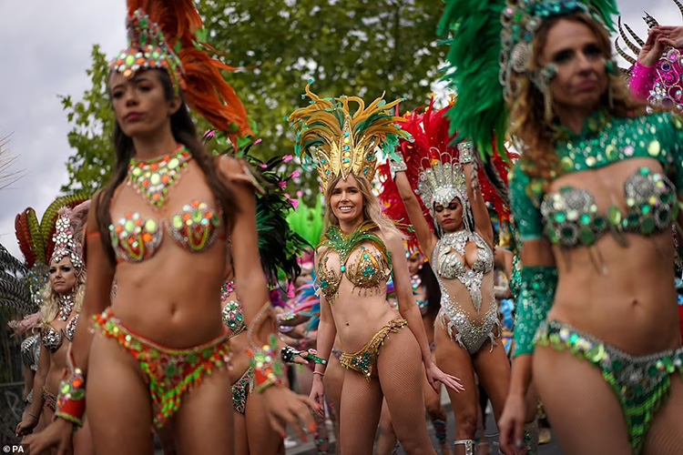 Samba dancers prepare before the start of the Notting Hill Carnival 2022 in west London